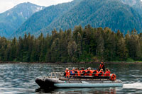 Juneau, Alaska, USA. Safari Endeavour cruise passengers in an inflatable boat in Icy Strait. Glacier Bay National Park adn Preserve. Chichagof Island. Juneau. Southeast Alaska. Today is the ultimate day of exploration. Set your course for arguably the richest whale waters in Southeast Alaska. Keep watch for the telltale blow of the humpbacks as you scour the nutrient-rich waters in search of whales, porpoise, sea lions, and other wildlife. 