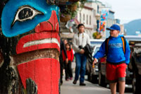 Juneau, Alaska, USA. Totem and tourists walking in the streets of Juneau. Alaska, USA. The City and Borough of Juneau is the capital city of Alaska. It is a unified municipality located on the Gastineau Channel in the Alaskan panhandle, and is the second largest city in the United States by area. Juneau has been the capital of Alaska since 1906, when the government of what was then the District of Alaska was moved from Sitka as dictated by the U.S. Congress in 1900. The municipality unified on July 1, 1970, when the city of Juneau merged with the city of Douglas and the surrounding Greater Juneau Borough to form the current home rule municipality. 