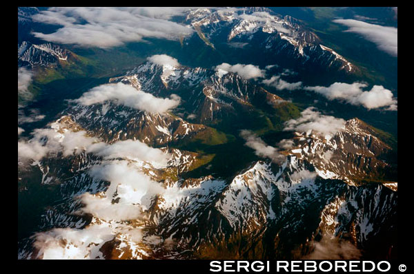 Aerial view of Coastal Mountains and glaciers north of Juneau, Southeast Alaska. Juneau has an amazing number of fully accessible mountains and ridges. This site will concentrate on four or five of the most popular. All take about 7-8 hours to climb and return at a moderate pace. Those interested in further climbs may want to contact the Juneau Alpine Club. A variety of pictures of their various hikes are posted at the club's site. These trails should not be tried by the timid. Mt. Juneau, Jumbo and McGinnis have various steep areas. All require stamina and care. Take lots of water, energy foods, and layered clothing (since the top can be windy and cold). Check the weather and bring rain gear if there is any chance of rain. Let someone know where you are going and when to expect you to return. A guide (or at least someone familiar with the trails) is strongly recommended. Views are spectacular and worth the effort.