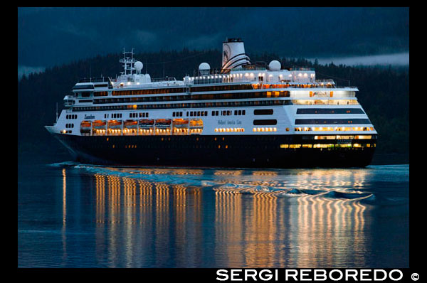 Zaandam, sailing near the South Franklin dock, at night, Juneau, Alaska. Designed to carry fewer guests while providing more space for maximum comfort, ms Zaandam is a prize in the mid-size ship category. Offering spacious public areas and plush accommodations, many staterooms have private verandahs. The musically themed Zaandam offers a unique shipboard atmosphere. Inspired by the world's great music, artifacts and memorabilia from a variety of musical genres decorate the ship. You'll find musical instruments such as Bill Clinton's saxophone and signed guitars from Queen, Iggy Pop, Eric Clapton and the Rolling Stones used as art objects throughout the ship. At the heart of Zaandam, in a soaring three-story atrium: a Baroque-style Dutch pipe organ, inspired by the traditional barrel organs still found on the streets of The Netherlands. Enjoy an onboard iPod self-guided tour of the complete Zaandam art collection.