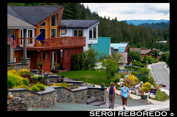 Modern wooden houses in a residential suburb of Douglas area,  Juneau. ALASKA, USA.  The Douglas area of Juneau is located on Douglas Island and is linked to downtown Juneau by bridge. You'll find that a lot homes for sale in Douglas, AK have great views of the Downtown area, Mount Juneau, Mount Roberts and up and down the Gastineau Channel. Douglas began life as a mining community and was once a city on it's own, rivaling Juneau. After the mine collapsed, in the early part of the last century, a gradual decline in population began and in the 1970's, the community decided to merge with the city of Juneau. Now it is a popular residential area, just 10 minutes from Downtown.