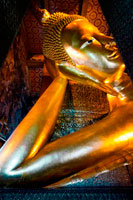 Bangkok. The Reclining Buddha, Wat Pho Temple, Rattanakosin Island, Bangkok, Thailand. Wat Pho (the Temple of the Reclining Buddha), or Wat Phra Chetuphon, is located behind the Temple of the Emerald Buddha and a must-do for any first-time visitor in Bangkok. It's one of the largest temple complexes in the city and famed for its giant reclining Buddha that measures 46 metres long and is covered in gold leaf. It’s an easy ten minute walk between here and the Grand Palace, and we recommend coming to Wat Pho second, because even though the golden Buddha here is just as popular many people don’t take the time to wander around the rest of the complex so the experience tends to be far more relaxing. 