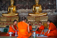 Bangkok. Monks praying in Wat Suthat Thepwararam Temple. Bangkok. Monks at Wat Suthat Thepwararam Ratchaworamahaviharn, Bangkok, Thailand, Asia. When we mention Wat Suthat Thep Wararam (or in short, Wat Suthat), we think of the huge and beautifully crafted Phra Sri Sakayamuni (or pronounced as "Si-Sak-kaya-mu-nee" or Sisakayamunee) Buddha image in the temple. To amulets collectors, Phra Kring from Wat Suthat has its magical appeal. This temple is located at Bamrungmuang Road, centre of Bangkok Metropolitan where sometimes locals called it as Krung Ratanakosin. It is actually not too far away from other tourist hot spots such as the Grand Royal Palace, National Museum etc. and within the few square kilometres, you can find the other temples of similar scales or interest such as Wat Boworniweithviharn, Wat Thepthidaram, Wat Mahannopphram, Wat Mahadhat, Wat Phra Chetuphon (Wat Pho), Wat Arun, Wat Rachapradit etc.  Wat Suthat was constructed in 1807 A.D. 