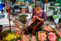 Bangkok. Woman seller of lotus flowers in Pak Khlong Talat , Flower market , Bangkok , Thailand. Pak Khlong Talat is a market in Bangkok, Thailand that sells flowers, fruits, and vegetables. It is the primary flower market in Bangkok and has been cited as a "place[] of symbolic values" to Bangkok residents. It is located on Chak Phet Road and adjacent side-streets, close to Memorial Bridge. Though the market is open 24 hours, it is busiest before dawn, when boats and trucks arrive with flowers from nearby provinces.