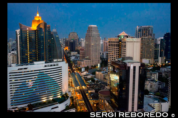 Landcape, views of Sukhumvit Road, sky train,  Westin, Sheraton and skyscrapers from Sofitel Bangkok Sukhumvit. Bangkok. Thailand. Celebrate L art de vivre in one the worlds most vibrant cities and in one of its top hotels Sofitel Bangkok Sukhumvit. Anticipate an exuberant bienvenue or welcome at the heart of this lively and cosmopolitan city. Savour rooftop champagne LOccitane fragranced spa journeys explorations of innovative Asian and European cuisine midnight workouts and afternoon swims amidst a lush landscape nine stories high. The downtown Bangkok hotels 345 rooms and suites soothe your senses with sophisticated surrounds of wood marble modern art home theatre systems luxurious bathrooms signature Sofitel MyBeds and panoramic cityscapes. For your Bangkok weddings meetings and events find an inspired and elegant home in Le Grand Ballroom and intimate Parisien-style salons. Meanwhile business travellers find a full range of expert business hotel services catering to their needs. Whether staying in our 5-star Bangkok luxury hotel for business or leisure you enjoy one the best locations in the city. The hotel stands on Sukhumvit Road one of the main arteries of Bangkok and places you steps from the BTS skytrain and MRT subway.