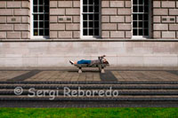 A woman lies on Donegall Square. Donegall Square is a square in the centre of Belfast, County Antrim, Northern Ireland. In the centre is Belfast City Hall, the headquarters of Belfast City Council. Each side of the square is named according to its geographical location, i.e. Donegall Square North, South, East and West. It is named after the Donegall family. Other streets to bear their name in Belfast are Donegall Road, Donegall Pass and Donegall Street. Donegall Place, the city's main shopping street, runs from the north side of the square. There’s a stop off at Bobby Sands’ mural on the side of Sinn Fein offices and the republican gift shop to hear about the hunger strike, and then down to the nearby International Wall that pictorially relates to “other civil wars” across the world. It’s obvious that across Belfast the murals are constantly being touched up and updated. Fascinating to see how every panel on the wall has been adapted to call for Marion Price’s freedom. The final stop on the political tour is the Crown Bar 