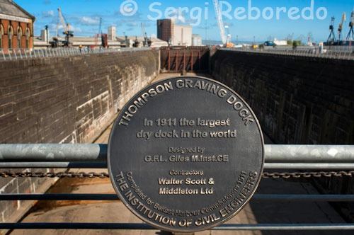 Thompson Graving Dock. The RMS Titanic, everyone has heard of it. The ship that the White Star Line said couldn’t sink, but which struck an iceberg on its maiden voyage and sank with the loss of more than 1500 lives. The hull of the Titanic was constructed next to its sister ship, the Olympic, in yard number 401 of the Harland & Wolff shipyards in Belfast and the massive Arrol Gantry supported the two ships as they grew upwards from their keels. The Titanic’s keel was laid down on 31st March 1909 and just over two years later it was launched – on 31st May 1911, it slid down Slipway number 3 to float for the first time. Despite the sheer scale of the gantry that supported the ship during the construction of the hull, there was still much work to be done to complete the ship and make it both seaworthy and suitable for carrying passengers – much of the superstructure such as the funnels, its engines and machinery and of course the luxurious furnishing and fixtures all needed to be fitted. Within an hour of its launch the Titanic was towed to the deepwater fitting wharf where much of this work was to be done, but some of the work required a dry dock – the Thompson Graving Dock had been constructed for just this purpose. After the fitting out process was completed the Titanic sailed for the first time under its own power on 2nd April 1912. Twelve days later it struck an iceberg.