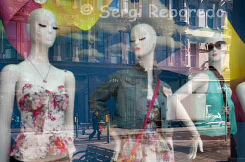 Reflections in a window of one of the shops in the center of Belfast. With award-winning designers, an array of shops to rival any European city and world class events such as FASHIONWEEK, Fall for Fashion or the Merchant Hotel’s decadent Fashion Teas, Belfast is a shopper’s paradise. Our compact city means that most shopping areas are within walking distance and for serious shoppers or those on a prescription of retail therapy, that means a lot! So whether it’s high street or budget shopping, designer or couture, the city offers a wealth of choice for every taste and pocket.  Leading in the style stakes is Donegall Place with a score of high street stores including Karen Millen and Zara and further down Royal Avenue CastleCourt hosts Warehouse, Gap, and Debenhams to name a few. Victoria Square, Belfast’s newest and most exciting shopping haven, brought a flurry of firsts to Belfast, including Apple, House of Fraser, CRUISE and Build-a-Bear and continues to surprise with previously unavailable brands and stores..  