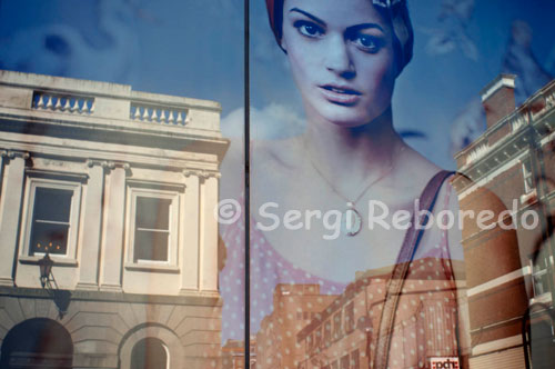 Reflections in a window of one of the shops in the center of Belfast. Belfast's city centre provides a healthy mix of high street names and one-off outlets. The main shopping areas are Donegall Place and Royal Avenue facing the City Hall, Cornmarket off Royal Avenue and, heading south, the Lisburn Road.  Donegall Place, Royal Avenue and Cornmarket are the main streets for familiar names including Marks & Spencer, Boots, Next and WH Smith. Cornmarket and its radial streets have a selection of well-known brands (River Island, French Connection, Habitat:) and low-budget options, especially along Ann Street.  Belfast city centre's biggest shopping mall is CastleCourt on Royal Avenue. If you want to explore smaller city centre outlets and craft shops, check out Donegall Arcade, Spires Mall, the Foutain Centre and the Dublin Road. Queen's Arcade houses several fine jewellery shops.  Botanic Avenue and the Cathedral Quarter are worth browsing for student-style clothes and accessories.  Lisburn Road, also known as Belfast's Bond Street or the Diamond Mile, is where the city's jet set swipe their plastic. It has a great range of designer boutiques, interiors showrooms, art galleries and speciality shops.  