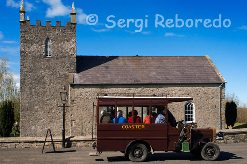 Ulster folk & transport museum. Ballycultra town Buildings. Church of Ireland At the time Kilmore Church was built in 1790, the Church of Ireland was still the Established Church in Ireland, and was supported by tithes.  This 10 per cent payment of the annual produce of land or labour was made to the church by the entire population, whether they belonged to it or not. This small Anglican (Protestant Episcopalian) church was built to accommodate 160 people, although parish records show the usual attendance was about 100 worshippers. An argument raged throughout the Anglican Communion in the 1840s and 1850s over the nature of worship and the use of rituals introduced by the Anglo-Catholic movement.  To heal this rift in the parish, the new rector who was appointed in 1868, built a new church nearby and this building served as a parish hall, a school and a store. In the 1880s it became common for Anglican churches to replace their box pews with rows of open pews. When Kilmore Church was being moved to the Museum, the layout of the original box pews was clearly visible on the floor and it was decided to reinstate the original 18th century interior. Original location: Kilmore, Crossgar, County Down 