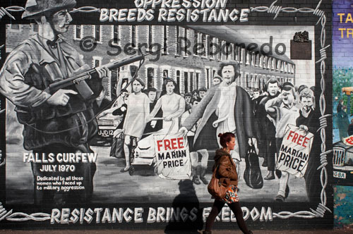 Oppression breeds resistance; resistance brings freedom. Mural in the Falls Road, a Catholic neighborhood of Belfast. Ulster. Northern Ireland. Falls Curfew July 1970 Dedicated to all those women who faced up to military aggression. Falls Road. Belfast, Northern Ireland. He also took us along Falls Road, in one of the main Catholic neighborhoods which has resisted Protestant rule (and what some at least used to consider occupation by the British army). In the photo to the left you can see an area in which a number of murals have been painted, some in commemoration of local Catholics (some combatants, both men and women, but also a number of bystanders, including children) who lost their lives over the years, including ten who fasted to their death in 1980 while in prison. The mural below gives a sense for the Catholic position: their resistance, including violent resistance, is a response to oppression, foreign control which itself has been ultimately enforced by police and army violence as well. 