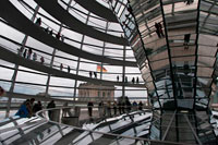Berlin. Germany. Mirrored cone inside the Reichstag Dome, in the german parlament (Reichstag), Berlin. The current Reichstag dome is an iconic glass dome constructed on top of the rebuilt Reichstag building in Berlin. It was designed by architect Norman Foster and built to symbolize the reunification of Germany. The distinctive appearance of the dome has made it a prominent landmark in Berlin. The Reichstag dome is a large glass dome with a 360 degree view of the surrounding Berlin cityscape. The debating chamber of the Bundestag, the German parliament, can be seen down below. 