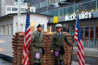 Berlin cold war Checkpoint Charlie Friedrichstrasse notorious border crossing American Soviet sectors east west wall. Checkpoint Charlie was the name given by the Western Allies to a crossing point between East Berlin and West Berlin during the Cold War. Other Allied checkpoints on the Autobahn to the West were Checkpoint Alpha at Helmstedt and Checkpoint Bravo at Dreilinden, southeast of Wannsee, named from the North Atlantic Treaty Organization's phonetic alphabet. Many other sector crossing points existed in Berlin. Some of these were designated for residents of West Berlin and West German citizens. Checkpoint Charlie was designated as the single crossing point (by foot or by car) for foreigners and members of the Allied forces. (Members of the Allied forces were not allowed to use the other sector crossing point designated for use by foreigners, the Friedrichstraße railway station. ) Checkpoint Charlie was located at the junction of Friedrichstraße with Zimmerstraße and Mauerstraße (which coincidentally means 'Wall Street') in the Friedrichstadt neighborhood, which was divided by the Berlin Wall. 
