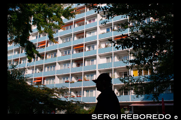 Apartment building Hansaviertel Berlin Germany. Apartment building at Altonaer Strasse 3-9 in Hansaviertel modernist housing estate in Berlin Germany. Flats at Hansaviertel.  Built as part of the Interbau Exhibition rehabilitation program, in which Le Corbusier, Walter Gropius, and Ludwig Mies van der Rohe also participated.  "The model apartment building in the Hansaviertel was built on the occasion of the Interbau exhibition in Berlin. This design sought to combine as far as possible the advantages of the private house with its own garden and those of the typical apartment house. Hence, conventional narrow balconies were expanded to become outdoor patios around which the rooms of each apartment were grouped. This 'intimate arrangement' gives the occupants the advantage of a small garden combined with complete privacy."  On bringing to apartment-block living some of the qualities of the private house:  "The conventional small corridor-like balconies were here transformed into patios around which the rooms of the apartments were grouped. This grouping around the open-air room created an intimate, private atmosphere.". 