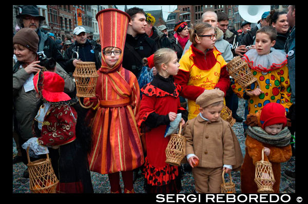 Children and teenagers dressed with costumes.  Music, dance, party and costumes in Binche Carnival. Ancient and representative cultural event of Wallonia, Belgium. The carnival of Binche is an event that takes place each year in the Belgian town of Binche during the Sunday, Monday, and Tuesday preceding Ash Wednesday. The carnival is the best known of several that take place in Belgium at the same time and has been proclaimed as a Masterpiece of the Oral and Intangible Heritage of Humanity listed by UNESCO. Its history dates back to approximately the 14th century. Events related to the carnival begin up to seven weeks prior to the primary celebrations. Street performances and public displays traditionally occur on the Sundays approaching Ash Wednesday, consisting of prescribed musical acts, dancing, and marching. Large numbers of Binche's inhabitants spend the Sunday directly prior to Ash Wednesday in costume. The centrepiece of the carnival's proceedings are clown-like performers known as Gilles. Appearing, for the most part, on Shrove Tuesday, the Gilles are characterised by their vibrant dress, wax masks and wooden footwear. They number up to 1,000 at any given time, range in age from 3 to 60 years old, and are customarily male. The honour of being a Gille at the carnival is something that is aspired to by local men