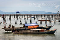 Fishing boats along the pier on Pulau Mabul. Its inhabitants, mostly Filipino immigrants, are engaged in fishing.