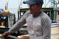 A fisherman on a boat in the port of Semporna. Borneo.