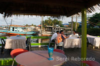 The tables by the sea in one of the restaurants in Semporna. Fishing boats can be moored port in a port in the back of the photograph.