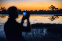 A man with binoculars enjoy the best sunsets in the Okavango Delta Fish Eagle Bar Camp Eagle Island Camp by Orient Express, outside the Moremi Game Reserve in Botswana. At Eagle Island will have one of the most unforgettable experiences: a safari boat. The nature as you have never imagined: hippos swimming in the water, crocodiles relaxed in the sun, herds of lions with their pups ... in short, a host of wildlife from the water. In the Delta will find more than a thousand species of animals including giraffes, leopards and elephants that will make your photos the envy of more than one. Finish the day with the sun, relaxing at the Fish Eagle Bar, one of the world's most romantic bars. Botswana is considered as one of the best kept secrets beauties and Africa. It is a natural wonder for his prodigious wildlife and variety of species thanks to its people and government are fully committed to safeguarding and protecting this natural treasure. That is why it has become a destination for safaris par excellence, where Big Five are the main stars of the show with some wonderful backdrop scenarios will not forget. A new opportunity to enjoy Botswana from the air to reach the semi-arid Savute in the Chobe National Park. At the heart of the park, considered the world capital of elephants, is the Savute, an area that personifies the eternal contrast of Africa. The Savute Elephant Camp is ideally located for its proximity to the river and found a few meters from a trough with stunning views that facilitate you enjoy wildlife without leaving the camp. The camp is located on the banks of the Savute Channel, offering a spectacular view of the elephants in their natural habitat.