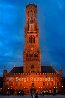 BRUGES : The Belfry and the Cloth Hall. The Market square is dominated by the cloth hall and the 83 meter high Belfry tower, one of the symbols of the city. The original cloth hall and tower date from 1240. The first tower, however, was destroyed by fire in 1280. At the time of the fire the four wings of the cloth hall already existed, as well as the two square segments of the belfry. The present octagonal lantern was added to the tower between 1482 en 1486. The wooden spire that crowned the tower was again destroyed by fire in 1493 en 1741. After the last fire it was never rebuilt. Like in most cities of the Low Countries the belfry tower was the place where the important documents of the city were preserved. At the same time such towers were used as watchtowers. Inside hung bells, each bell having a distinct sound and function (e.g.: bells for danger, bells for important announcements, bells to indicate the time, etc.).