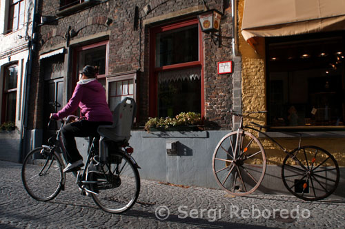 Bruges, Belgium via bike. It has been many years since I first visited Bruges, Belgium, but one image stays strong in my memory – bicycles. They are everywhere in this tiny town, about 50 miles northwest from Brussels, and are definitely the recommended mode of transportation while visiting. As you arrive in the train station, you will find the first opportunity to rent bikes, in the station, for 6,50 Euros for half a day, 9,50 Euros for a full day. The bikes must be returned before 7:30pm, and you are required to leave a deposit. If you prefer a guided tour, by bicycle of Bruges, Toerisme Brugge lists several bike tour companies, including Pink Bear Bike Tours, which arranges leisurely rides to nearby Damme via a tree-lined canal. Many photo opportunities abound, with picturesque windmills and Flemish villages. And if you are interested in exploring the country of Belgium via bike, it is good to know that bikes can be taken on trains, although you will need a special bike + train ticket. In addition, you are advised to travel off-peak with your bike, and follow the train conductors as to where to load and unload your bike. 