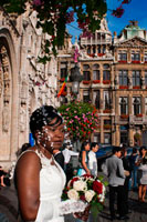 On Saturday morning weddings are held in the Hôtel de Ville (city hall). The town hall, which occupies the southwest facade is the only medieval building left standing today and was built between 1402 and 1455 probably by Jean Bornoy. Its tower, asymmetrical with respect to the building, 96 feet high, is of Gothic style and was designed by Jean van Ruysbroeck in 1449. An urban legend that the architect, to verify the alleged error that the tower will be located in the center, got into it and he jumped, although in truth both parties were not built at the same time. Atop the tower is a high bronze statue of five meters of the archangel Michael, patron saint of Brussels, slaying a dragon or devil. The left part of the council consists of twelve arches, including the bell tower, representing the twelve stages wet alchemy. Instead, the right side only has seven arches, counting the bell, symbolizing the new alchemy dry in seven stages. The facade is decorated with numerous statues representing nobles.