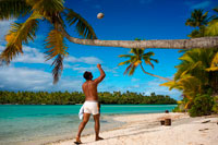 Aitutaki. Cook Island. Polynesia. South Pacific Ocean. An inhabitant of the island takes up a coconut palm tree on the beach in One Foot Island. One Foot Island is asmall island in the district of Aitutaki of the Cook Islands in Australia. It is also known as Tapuaetai and is one of 22 islands of the atoll. You can only reach this island via a short boat trip from the main island. It is said that One Foot Island gives the visitors the best view of the Aitutaki lagoon. It was awarded “Australia’s Leading Beach” at the World Travel Awards held in Sydney in June 2008. The island is uninhabited, but you can buy small things at the local shop. The beaches of OneFoot Island are white, and the water is crystal clear. This is not only a paradise for divers and snorkelers but also for those wanting to enjoy the beach and the sand. Climate: Since the islands are South of the equator, the seasons are opposite to those of Europe and North America. The cooler, drier season is from April to November and the warmer, more humid season is from December to March. The average temperature is 27 Celsius. Regularly listed as one of the most romantic places on Earth, and the second-most visited island in the Cooks, Aitutaki is famous for its impossibly crystal-clear, turquoise water of its central lagoon, tiny motus (islets) and pristine, palm-shaded beaches. Inland, Aitukati's rolling hills are a patchwork of banana plantations and coconut groves. 