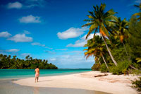 Aitutaki. Cook Island. Polynesia. South Pacific Ocean. A tourist walks along the edge of the palm-fringed beach in One Foot Island.  Stamp Your Passport: Visit Aitutaki’s One Foot Island, where you’ll enjoy the incredible blue lagoon and a mouth watering beach barbecue, as well as a chance to receive Aitutaki’s trademark One Foot passport stamp.. With a vast, sparkling lagoon rivaling Bora Bora’s – but with a fraction of the visitors – Aitutaki just might be the world’s most beautifully-remote island. Just a 45-minute flight from the main island of Rarotonga, Aitutaki and its surrounding atolls served as the tropical backdrop for “Survivor: Cook Islands.” One of 22 islands in the Aitutaki atoll, One Foot Island (or Tapuaetai, “one footprint”) is both dreamily-exotic and nearly deserted. It’s the perfect place to laze on a powder-white beach or float in the knee-high lagoon. While it may look totally deserted, One Foot is home to one top attraction - a small hut containing one of the world’s most remote post offices. Don’t forget to bring your passport and you’ll depart paradise with a footprint-shaped passport stamp to remember it by.  Atiu Island, also known as Enuamanu (‘land of the birds’) lies 187 kilometres north east of Rarotonga. The third-largest island in the Cooks is over eight million years old. It’s also an ecologist’s dream and a magnet for the adventurer. On the edge of the island’s flat-topped central plateau you’ll find Atiu Villas, the island’s most developed vacation spot. You’ll also find 28 untouched beaches that are almost unvisited – except by those seeking a beautiful, secluded spot. Beautiful Aitutaki. It’s believed that the islanders on Aitutaki are descended from Ru, a seafaring warrior who settled there with his four wives. 