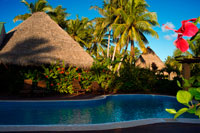 Aitutaki. Cook Island. Polynesia. South Pacific Ocean. Swimming pool of Aitutaki Lagoon Resort & Spa Hotel. Right beside the Activities Hut is the waterfalls swimming pool. Which is handy, as that’s also right beside Aroa Beach. And because The Rarotongan is luckily located right on the sunshine southwest coast, this means there’s sunshine all day on the freshwater pool, the beach, and the lagoon – right up until sunset that is (often a glorious, blazing island sunset). There’s plenty of comfortable pool loungers to enjoy, so grab your complimentary pool / beach towel from the Activities Hut and make yourself comfortable for another day in Paradise. After you’ve soaked up some rays, take a cool dip in the pool. Someone’s gotta do it. The sublime Aitutaki Lagoon Resort & Spa rests effortlessly on its own secluded, private island of Motu Akitua - the only private island resort in the Cook Islands. Just a 2 minute ride from the main island of Aitutaki by small private ferry, the isle of Motu Akitua is encircled by broad, expansive beaches the colour of champagne. From here, you as our guest are able to enjoy the only resort facing directly onto the world's most beautiful lagoon, and from here, you can drink in spell-binding views of one of the Wonders of the World to your heart's deep content. Nothing will prepare you for the intensity, the vibrancy, the omniscience, of the lagoon's blue expanse. So intense, so expansive, it is not just a colour you see, it is a blue you feel with every fibre of your being. This is the reason you have journeyed all the way across the oceans, to see, to feel, to truly experience the world's most beautiful lagoon. Staying at The Aitutaki Lagoon Resort & Spa, you will have the opportunity not just to see Aitutaki Lagoon as a day tourist might, but to really experience this true Wonder of the World in all its moods. 