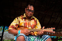 Aitutaki. Cook Island. Polynesia. South Pacific Ocean. Playing the ukulele (typical Polynesian guitar) in Aitutaki Punani Culture Tours. Tahitian ukulele. Ideally, the best way to learn the uke is to spend a bit of time in Tahiti, The Cook Islands, Rapa nui, Marquesas, Niue or Aotearoa(NZ) and just jam with the locals. Like all music in the pacific, the uke is generally learnt from a young age and gradually picked up over time from family or friends. Polynesian music is also learnt and played by ear, so when someone starts singing or playing a song you just listen for the key and join in. If you can play a Hawaiian uke then you should be able to pick up the Tahitian uke a lot faster as the chord patterns are basically the same. The main difference is the lead work and strumming techniques/patterns which take a bit of time to master. Koata from Kanua ukuleles has a series of excellent instructional videos (See below) to get you started.  Strumming: One of the hardest things about playing island ukes is the fast strum. On a guitar or Hawaiian uke, it's usually done flamenco style using all the fingers but with the Island style uke we just use a pick. The first thing you need to do is practice getting a rapid strum action by pivoting from the wrist. Once you get a clear and even vibrating sound going, you can then start creating funkier rhythms by flicking the wrist a bit harder on the particular down strum you want to stress. 