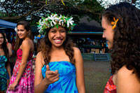 Rarotonga Island. Cook Island. Polynesia. Some nice teenagers dressed in Polynesian around the Punanga Nui Markets.  Cook Island market day is every Saturday down at the Punanga Nui Markets (located in Avarua, which the locals call Town) for locals and visitors alike. Locals tend to head to the markets early (before breakfast) to pick up bargains on fresh fruit and vegetables. Here local delicacies can be one third the price you will find them at the supermarket. Most visitors take a more leisurely approach and tend to get to the markets mid morning. To get there you can either catch the Island Bus to Avarua or drive. Parking space is easily found down at the eastern end of the market. At the eastern end of the market you will find an array of craft and clothing stalls selling colourful sundresses, pareu's, ukuleles, black pearls and jewellery. Be sure to look out for the Cook Islands tivaivai (quilts). They are beautifully handmade bedspreads of tropical designs and colours. The tivaivai art form is unique to the Cook Islands and are works of love by the women who spend hours making the sought after bedcovers. 