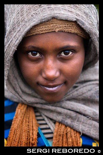 Portrait of a child in The National Park Simien mountains. The mountains of Ethiopia are old and rounded. Few beak-shaped peaks appear in the landscape, despite the height. The mountainous horizon is wavy and sometimes flat profiles, unlike usual in the alpine landscape.