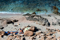 Formentera. Nude couple in Es caló des Mort, Migjorn beach, Formentera, Balears Islands, Spain. Holiday makers, tourists, Es caló des Mort, beach, Formentera, Pityuses, Balearic Islands, Spain, Europe.