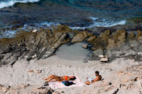 Formentera. Read and relax in Es caló des Mort beach, Migjorn beach, Formentera, Balears Islands, Spain. Holiday makers, tourists, Es caló des Mort, beach, Formentera, Pityuses, Balearic Islands, Spain, Europe.