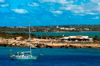 Formentera. Sa Sequi Restaurant, Cala Savina beach, Formentera island, Balears Islands, Spain. Mediterranean food. A yacht sailing. 