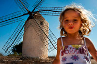 Formentera. Funy girl in the windmill, Formentera, Balearic Islands, Spain. Old Windmill in el Pilar de la Mola on the island Formentera, Balearic Islands, Spain
