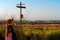 Formentera. Tourists with children taken pictures at cycle route sign. Pudent Lake. Formentera. Balearic Islands, Spain, Europe.