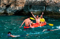Formentera. Friends doing kayaking on Cala Sahona, Formentera, Balearics Islands, Spain. Barbaria Cape.