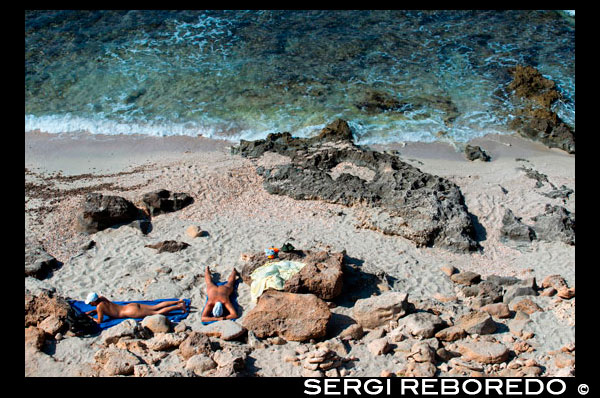 Nude couple in Es caló des Mort, Migjorn beach, Formentera, Balears Islands, Spain. Holiday makers, tourists, Es caló des Mort, beach, Formentera, Pityuses, Balearic Islands, Spain, Europe. Spain; Formentera; Migjorn; beach; nude; naked; natural; eco; nudist; island; balearic; mitjorn; es calo; calo; des mort; des; morts; swim; couple; swimming; Baleares; atrraction; destination; Europe; sand; European; holiday; travel; islands; blue; turquoise; mediterranean; photos; place; spanish; sun; beaches; break; calm; clear; coast; color; colour; dawn; mitjorn; day; daybreak; destination; dune; early; flat; formentera; holiday; horizon; horizontal; island; islas; landscape; mediterranean; migjorn; mist; bodies; body; busy; coast; coastline; coastlines; coasts; crowded; day; daylight; daytime; de; during; europe; european; outside; morning; pitiuses; sandy; scene; sea; south; spain; summer; vacation; view; wave; waves; tourism; touristic; vacation; view; Balearics; beautiful; beauty; paradise; fun; happy; coastal; paradisiac; popular