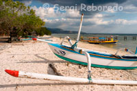 Some boats rest on the sandy beach in the west of the island, near the pier Bounty Resort. Gili Meno.