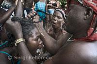 A woman in a trance is aided by the rest of voodoo devotees. Most of Voodoo rituals begin with Christian prayers recited in French, then switches to the Creole language, a combination mainly of French, Spanish, African and 'patois' - the latter word that the French applied with contempt to what they do not understand. Begin the ecstatic dances and drums to increasingly frantic pace. The activities of sorcery and spells, contain fetishism (word derived from the Portuguese feitiço 'dating from 1760) then follow pagan cults of sacrifice, trance handling and communication with their gods, whose names indicate their origin in Dahomey. Voodoo was persecuted in Haiti since 1685, when Catholic priests, managers of plantations and slaves, banned 'songs and the assemblies of blacks with or without drums. That contributed to its spread as these were clearly anti-slavery meetings.