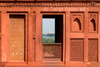 Taj Mahal- As Seen from Agra Fort Window. Near the gardens of the Taj Mahal stands the important 16th-century Mughal monument known as the Red Fort of Agra. This powerful fortress of red sandstone encompasses; within its 2.5-km-long enclosure walls; the imperial city of the Mughal rulers. It comprises many fairy-tale palaces; such as the Jahangir Palace and the Khas Mahal; built by Shah Jahan; audience halls; such as the Diwan-i-Khas; and two very beautiful mosques. The Red Fort and the Taj Mahal bear an exceptional and complementary testimony to a civilization which has disappeared; that of the Mogul Emperors. Agra's history goes back more than 2; 500 years; but it was not until the reign of the Mughals that Agra became more than a provincial city. Humayun; son of the founder of the Mogul Empire; was offered jewellery and precious stones by the family of the Raja of Gwalior; one of them the famous Koh-i-Noor. The heyday of Agra came with the reign of Humayun's son; Akbar the Great. During his reign; the main part of the Agra Fort was built.