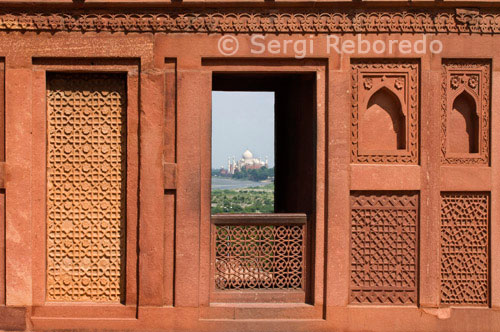 INDIA CROSSING THE RIVER GANGES Taj Mahal- As Seen from Agra Fort Window. Near the gardens of the Taj Mahal stands the important 16th-century Mughal monument known as the Red Fort of Agra. This powerful fortress of red sandstone encompasses; within its 2.5-km-long enclosure walls; the imperial city of the Mughal rulers. It comprises many fairy-tale palaces; such as the Jahangir Palace and the Khas Mahal; built by Shah Jahan; audience halls; such as the Diwan-i-Khas; and two very beautiful mosques. The Red Fort and the Taj Mahal bear an exceptional and complementary testimony to a civilization which has disappeared; that of the Mogul Emperors. Agra's history goes back more than 2; 500 years; but it was not until the reign of the Mughals that Agra became more than a provincial city. Humayun; son of the founder of the Mogul Empire; was offered jewellery and precious stones by the family of the Raja of Gwalior; one of them the famous Koh-i-Noor. The heyday of Agra came with the reign of Humayun's son; Akbar the Great. During his reign; the main part of the Agra Fort was built.