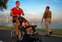 Woman running with her baby in Balboa Avenue skyline skyscraper road seawall new. Skyline, Panama City, Panama, Central America. Cinta Costera Pacific Ocean Coastal Beltway Bahia de Panama linear park seawall skyline skyscraper modern. Coastal Beltway (Cinta Costera), Panama City, Panama. Panama City is one city in Central America where congestion has reached crisis point. The city is going through an unprecedented period of stability and investment and there are ample public funds for infrastructure improvement projects.