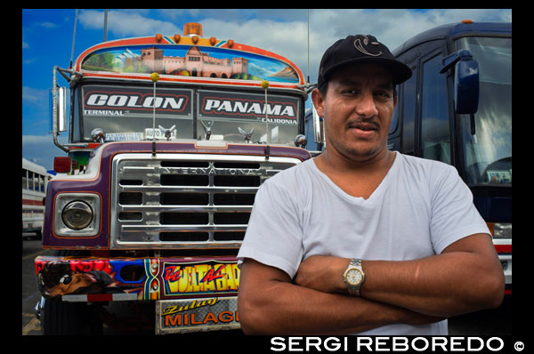 Driver of BUS RED DEVIL DIABLO ROJO PAINTED BUS PANAMA CITY REPUBLIC OF PANAMA. Albrok bus station terminal. Panama. Here comes the Diablo Rojo, the Red Devil bus blasting its air horn and fishtailing around a fellow “demon” just in time to claim Irma Betancourt and other morning commuters. Suffice it to say the Red Devils earn their name. “They are crazy,” said Ms. Betancourt, 33, a housekeeper at a downtown hotel, boarding on a main boulevard. “We all know that. All they care about is getting the fare. So many times we have almost hit somebody.”  Wandering around Panama City it’s hard to miss these crazy fuckin buses rolling around the city. Converted school buses are used as inexpensive public transportation. Each bus in the city is individually decorated which makes an interesting catch whenever rolling around. The average cost to ride one of these buses is 25 cents!  “Almost” may make her bus one of the lucky ones, as they are known to have taken more than a few souls for the sake of a pickup.  Her bus on a recent morning is like hundreds of others, a converted, cast-off American school bus ablaze with color, usually heavy on the red.  As if painted by a graffiti artist addicted to action movies and sports, they often boast fanciful, dreamy scenes, including, improbably, a looming Dumbledore from the Harry Potter movies glaring at Ms. Betancourt as she climbs aboard.  Reggaetón, salsa and other bass-heavy music concuss the air, to attract riders to the privately owned buses. Growling mufflers contribute to the soundtrack of the streets. And no self-respecting grille lacks a wild string of Christmas lights.  Typical fare: 25 cents.  “They evolved into the most visually dominant aspect of Panama City,” said Peter Szok, a professor at Texas Christian University in Fort Worth who has studied the buses and the folk art of Panama.  It is a tradition elsewhere in the region as well, in other Panama cities as well as in countries like Suriname, where the buses are adorned with politically tinged portraits of heroes and outlaws. But here, at least, the ride is coming to an end.  The buses, many of them retired from Florida schools, have been the backbone of public transit here for more than four decades, with the tradition of decorating vehicles used for public transportation going back even further. Mr. Szok traces the art form to a desire to reflect Latin music styles and an idealized life.  Panama City, however, is rapidly modernizing, with a towering skyline and sprawling shopping malls that promoters hope will put it on the map as another Singapore.  With that has come a push for order. A subway is being dug. Roadways are being built or planned. The Red Devils, owned and operated by their drivers with no real set schedule, are being phased out in favor of something decidedly more vanilla and benign, a Metro Bus system with generic boxy white vehicles familiar in any cities. The only dash of a color is an orange slash.  “Safe, comfortable, reliable,” is the slogan. There is even a route map.  President Ricardo Martinelli, whose administration has championed the new system, has pointed to the new buses as a sign of progress, blaming the Red Devils for accidents and accusing them of unreliable service.  “They will race from one end of the city to the other, killing people, killing themselves,” he said in a speech in Washington in April. “Yeah, a lot of people were killed.”  But the Metro Buses, too, are drawing complaints, mainly for slow service. The 25-cent fare on most routes is expected to rise to 45 cents next year, and is already drawing grimaces. Some have taken to calling them the Diablos Blancos, the White Devils.  “Hey! The line starts back there,” several people shouted at one crowded downtown Metro Bus stop as their ride finally arrived in a downpour.  “Look at this long line and little bus shelter,” said David Polo, 33, who had been waiting for more than 20 minutes. “The new buses may be safer, but they need more of them.”  Panama’s transportation officials said the Red Devils, numbering about 1,200 in recent years, would be gone by the end of this year, but the plan has been delayed more than once as the new system seeks to hire and train drivers.  As the Red Devils disappear — some of them, in the ultimate twist of fate, converted back to school buses, and others dismantled for scrap or sitting in bus boneyards — something a bit unexpected has emerged.  Sympathy for the Red Devils.  The nostalgia ranges from the tongue in cheek — a “Save the Diablo Rojo” YouTube video purports to mourn the end of tourists’ losing their wallets, among other things, on them — to genuine regrets.  “It is a loss of part of our culture,” said Analida Galindo, a co-director of the Diablo Rosso art gallery in the historic Casco Viejo neighborhood. Yes, the gallery name is a play on the Red Devils’ name.  The gallery sells bus doors painted by one of the more prolific Red Devil artists, Oscar Melgar, for $2,500 (no takers yet).  Mr. Szok said the painters were largely self-taught, many of them the sons of West Indian immigrants, though some in later years had gone to art school. They typically charged $2,000 and up to paint the buses, meaning some are a kaleidoscope of images while, in others, the yellow has been barely painted over, depending on the wherewithal of the driver.  “It was a great tradition that people are going to miss,” said one of the painters, Ramón Enrique Hormi, known as Monchi. “Here it is Christmastime, and what am I going to do? I have nothing.”  Some owners, too, have complained that the $25,000 that the government is offering them in compensation for giving up their buses may sound generous but will not carry them very far.  Several drivers said they could not get jobs with Metro Bus because of their poor driving records, though the new system has hired many Red Devil drivers.  Other drivers said they had long held second jobs and would find other work.  “Everything has to come to an end someday,” one driver, Juan Estanciola, said on a recent day outside his modestly painted bus, which is mostly white with purple trim and bears sayings like “Don’t let my presence mess with your mind.”  He spoke at the door of his bus, which had just collided with a taxi on a rainy afternoon.  “It was his fault,” he said. “He cut in front of me. They don’t know how to drive.”