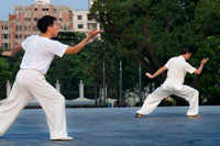 China, Shanghai, morning tai chi exercise on The Bund. Shanghi Bund : Early morning tai chi exercises with swords on the Bund in Shanghai China. The best taichi lessons I've had were from an old guy who practiced outside at 7am every morning. I learned 4 excellent techniques that I still use in my MMA training on a regular basis- a method of catching a kick and throwing your opponent, redirecting a straight punch and countering in the same motion, countering double underhooks with a throw, and escaping a shoulder lock while setting up your own.  It's a really fascinating martial art because every one of those dance like movements