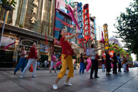 China, Shanghai, Nanjing Road, tai chi, exercises, people before opening the shops. Evening tai chi group exercising on Nanjing Dong Lu, Shanghai. Nanjing Road (Chinese: ???; pinyin: Nánj?ng Lù) is the main shopping street of Shanghai, China, and is one of the world's busiest shopping streets. It is named after the city of Nanjing, capital of Jiangsu province neighbouring Shanghai. Today's Nanjing Road comprises two sections, Nanjing Road East and Nanjing Road West. In some contexts, "Nanjing Road" refers only to what was pre-1945 Nanjing Road, today's Nanjing Road East, which is largely pedestrianised. Before the adoption of the pinyin romanisation in the 1950s, its name was rendered as Nanking Road in English. 