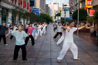 China, Shanghai, Nanjing Road, tai chi, exercises, people before opening the shops. Evening tai chi group exercising on Nanjing Dong Lu, Shanghai. Nanjing Road (Chinese: ???; pinyin: Nánj?ng Lù) is the main shopping street of Shanghai, China, and is one of the world's busiest shopping streets. It is named after the city of Nanjing, capital of Jiangsu province neighbouring Shanghai. Today's Nanjing Road comprises two sections, Nanjing Road East and Nanjing Road West. In some contexts, "Nanjing Road" refers only to what was pre-1945 Nanjing Road, today's Nanjing Road East, which is largely pedestrianised. Before the adoption of the pinyin romanisation in the 1950s, its name was rendered as Nanking Road in English. The history of Nanjing Road can be traced back to the year 1845. At that time it was called “Park Lane”,