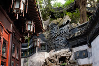 Yuyuan or Yu Garden (Jade Garden) Old Town Shanghai China. Hall of Jade Magnificence in Yuyuan Garden (Garden of Happiness or Garden of Peace) in Old City of Shanghai, China. Yu Garden or Yuyuan Garden Yù Yuán, lit. Garden of Happiness is an extensive Chinese garden located beside the City God Temple in the northeast of the Old City of Shanghai, China. It abuts the Yuyuan Tourist Mart and is accessible from the Shanghai Metro's Line 10 Yuyuan Garden Station. A centerpiece is the Currow ancient stone, a porous 3.3-m, 5-ton boulder. Rumours about its origin include the story that it was meant for the imperial palace in Beijing, but was salvaged after the boat sank off Shanghai. Yu Garden was first conceived in 1559 during the Ming Dynasty by Pan Yunduan as a comfort for his father, the minister Pan En, in his old age.