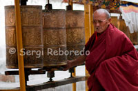 A monk spinning the prayer wheels inside the Tashilumpo Monastery, located in Shigatse, Tibet. Tashilumpo monastery is huge, as befits a building that holds 700 people.